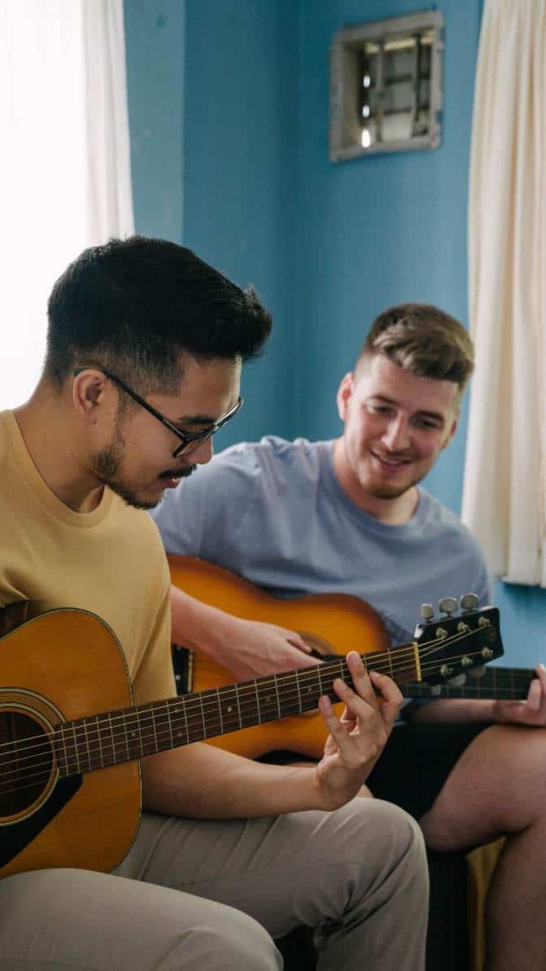 Two friends playing guitar during music therapy in Chattanooga, TN. 